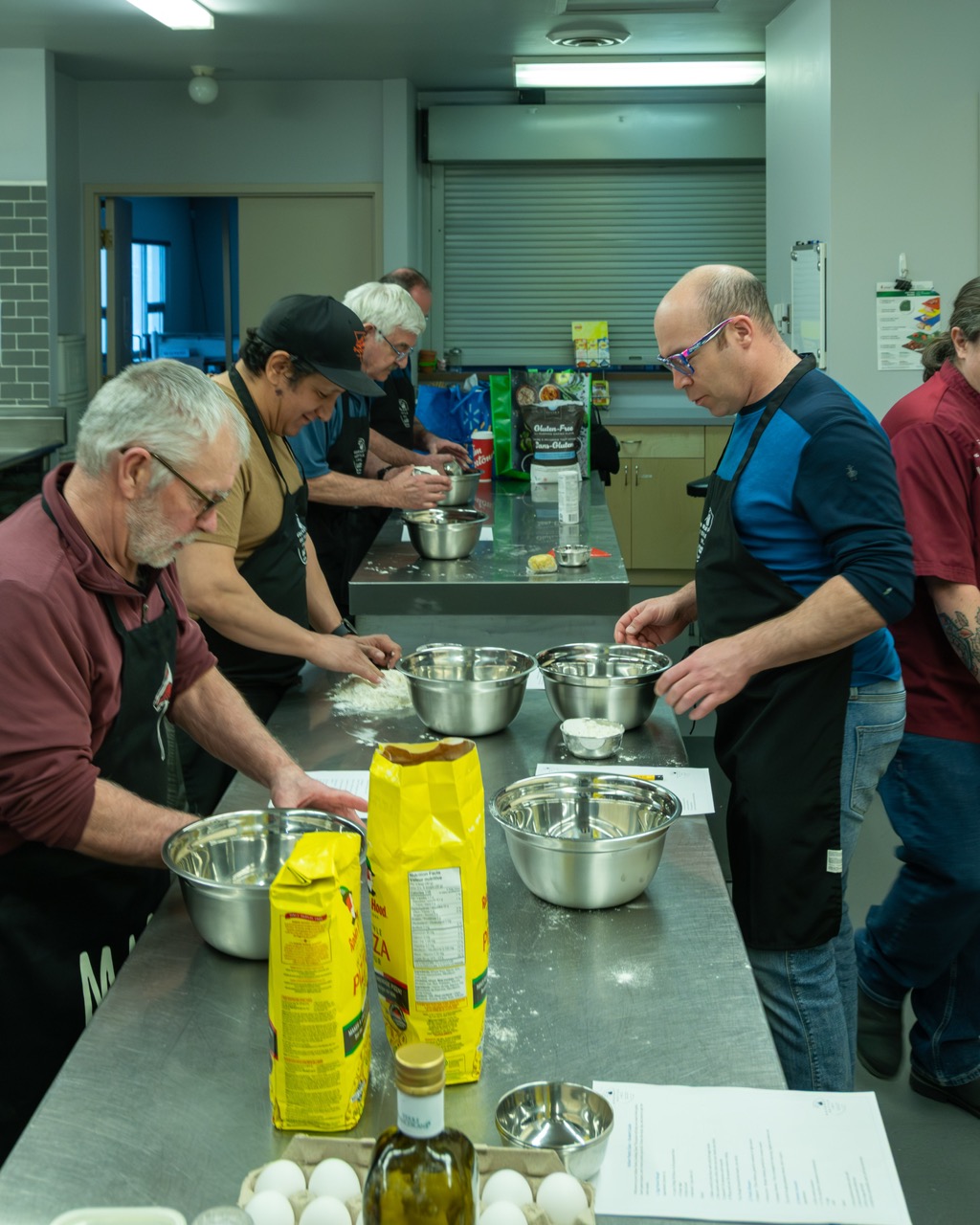 Hinton Men's Shed volunteers preparing food together in the kitchen